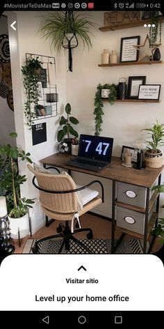 a desk with a laptop computer on top of it next to potted plants and pictures