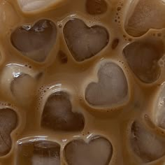 some brown and white heart shaped bubbles in liquid