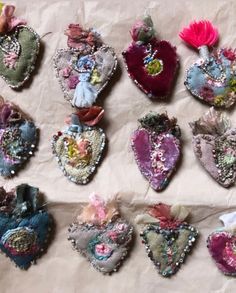 a bunch of heart shaped brooches on a piece of paper