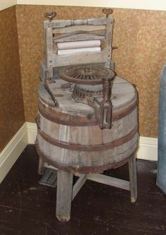 an old wooden chair sitting on top of a barrel