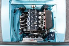 the engine compartment of an old blue car