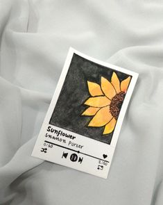 an image of a sunflower on the back of a white shirt with black and yellow details