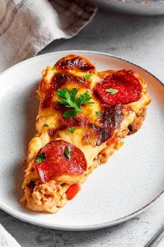 a slice of pizza with pepperoni and cheese is on a plate next to a fork