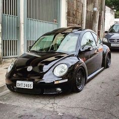 a black car is parked on the side of the street