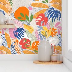 the wallpaper in this kitchen is painted with bright colors and has tropical leaves on it