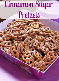 a box filled with cinnamon sugar pretzels sitting on top of a purple table