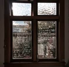 a window with writing written on it