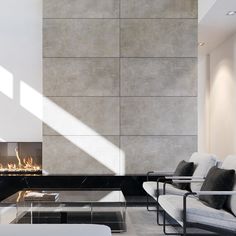 a living room with two couches and a fire place in the wall next to it