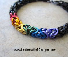 a multicolored bracelet with black beads on it's sides and an intertwined design