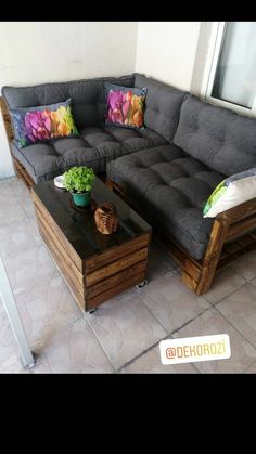 a couch and coffee table in front of a window