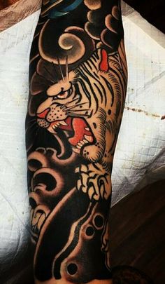 a man with a tiger tattoo on his arm