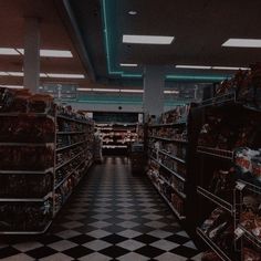 an empty grocery store aisle with shelves full of food in the middle and on the other side