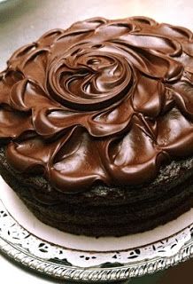 a chocolate cake sitting on top of a white plate