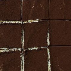 brown and white squares are arranged on the ground