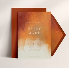 an orange and white wedding card with the words, family mark written in gold on it