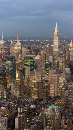 an aerial view of new york city at night with the empire building in the foreground