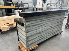 a counter that is sitting in the middle of a room with some wood pallets