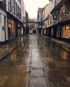 an empty city street is shown in the rain