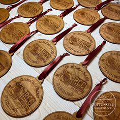 several wooden badges with red ribbons around them