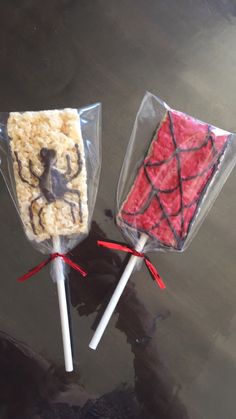 two lollipops decorated like animals on sticks