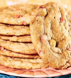 a stack of cookies sitting on top of a pink plate