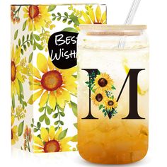 a mason jar with sunflowers and the letter m on it next to a box