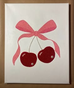 a painting of two cherries with a pink bow on it's head and beaded ribbon