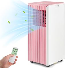 a person holding a remote control next to a pink and white air conditioner