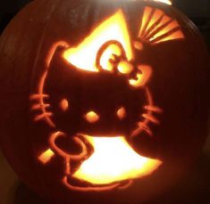 a carved pumpkin with an image of a cat on it's face in the center