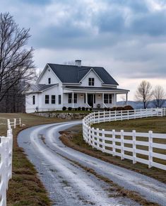 a white house with a driveway leading to it