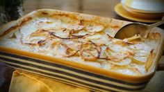 a casserole dish filled with potatoes and onions