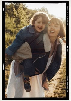 a woman carrying a child on her back