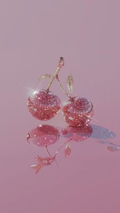 two pink vases sitting on top of a reflective surface