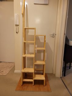 a wooden shelf sitting on top of a hard wood floor