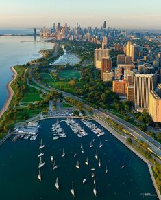 an aerial view of the city and harbor with sailboats