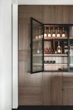 an open cabinet with many bottles on it