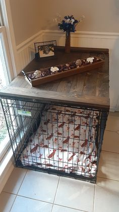 a cage with food in it sitting on top of a table next to a window