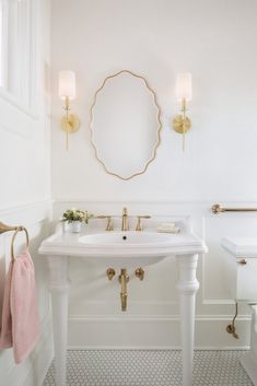 a bathroom with a sink, toilet and mirror