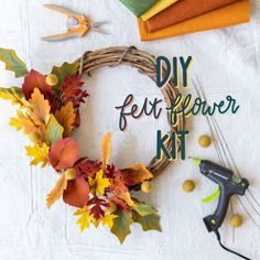 the diy felt flower kit is laid out on a table with scissors and other crafting supplies