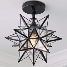 a light that is hanging from the ceiling in a room with a star design on it