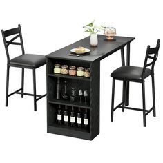 a kitchen table with two chairs and a wine rack on the bottom shelf next to it