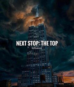 a tall building with the words next stop the top in front of it and dark clouds