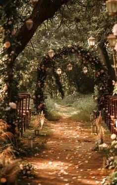 an outdoor wedding ceremony with lanterns and flowers on the path leading to the altars