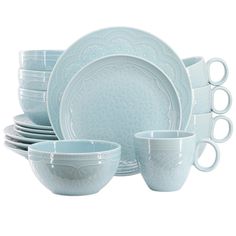 a set of blue dishes and cups with white rims on the top, in front of a white background