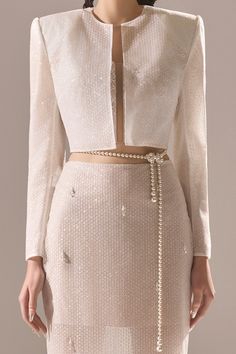 Indulge in luxury and elevate your wardrobe with our jacket. With its intricate sequin detailing and elegant long sleeves, this jacket adds a touch of opulence to any outfit. Get ready to make a statement and shine like the star you are. * Note: Include a belt if you buy full set (jacket, crop top, skirt). Outfit With Pearls, Sunday Top, White Skirt Outfits, Jacket Crop, Ethereal Dress, Mean Blvd, Clothing Sites, Crop Top Skirt, Fashion Inspiration Design