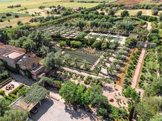 an aerial view of a large garden with lots of trees and bushes in the middle