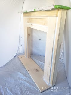 an unfinished fireplace being built in the corner of a room with white paint on it