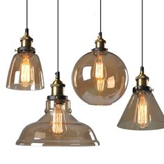 three glass pendant lights hanging from the ceiling