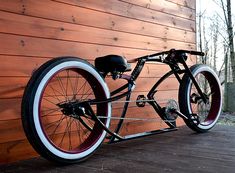 a bike is parked against a wooden wall