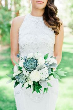 a woman in a wedding dress holding a bouquet